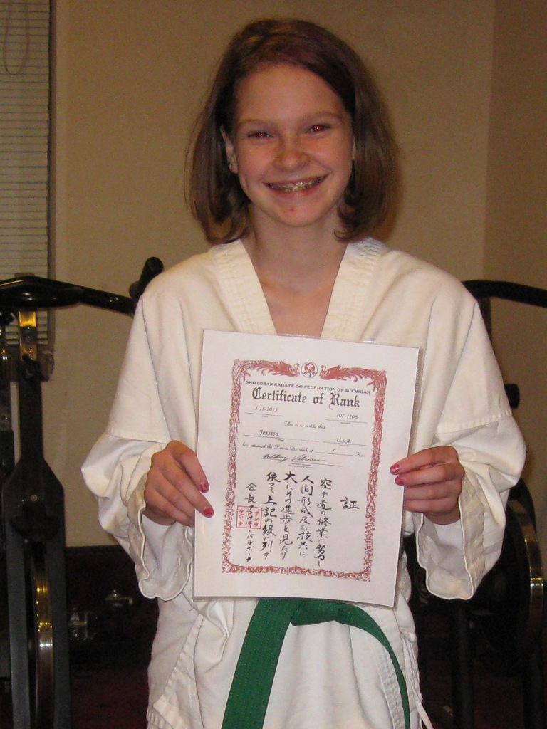 Jessica with newly awarded certificate for green belt Jessica with newly awarded certificate for green belt